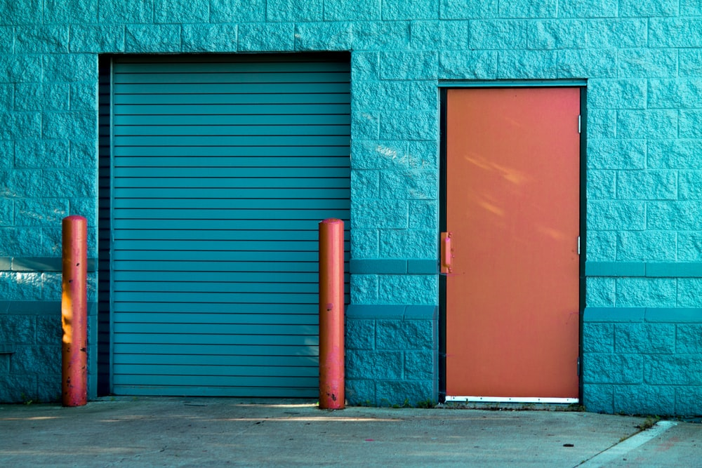 A shutter gate next to a door