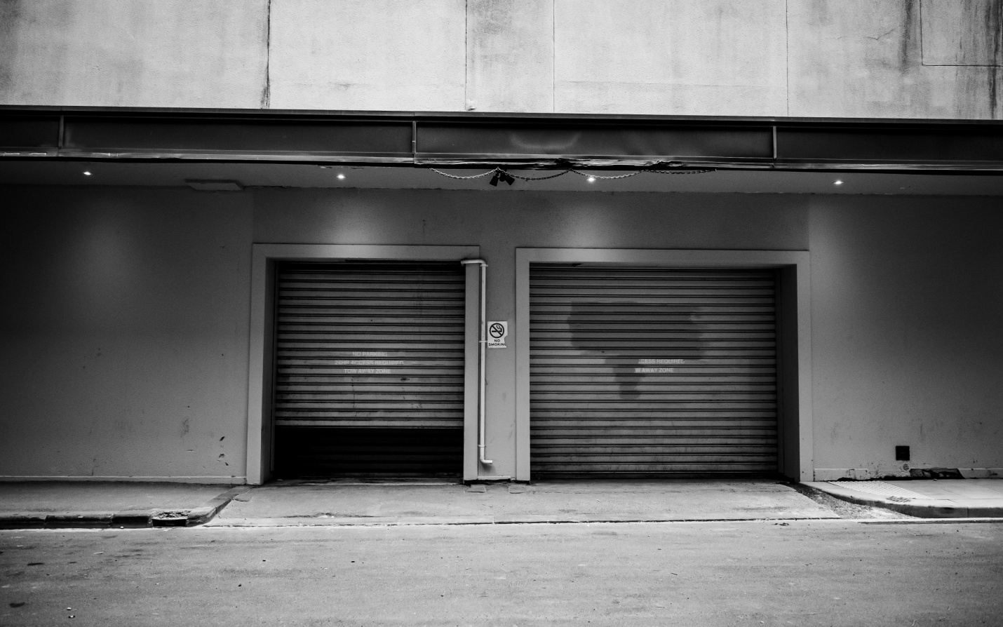 A couple of grey, steel rolling gates