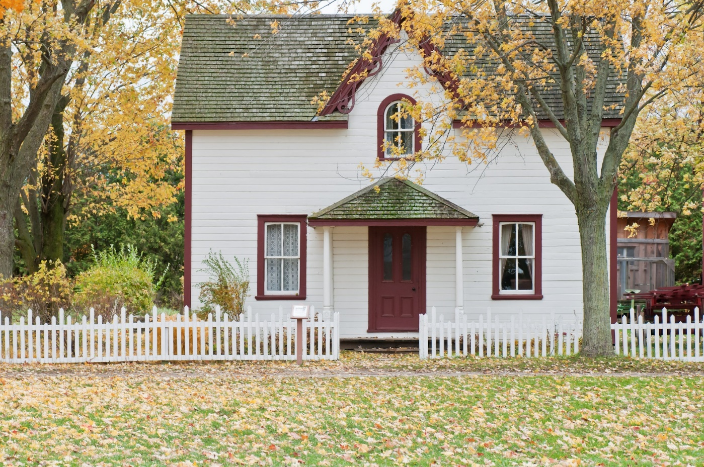 White and Red Wooden House with a Fence
