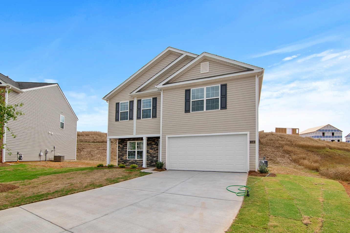 White Garage Door on a Beige Home