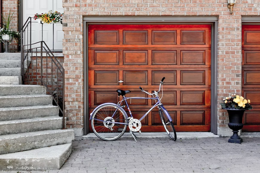 A wooden garage door with a garage door opener