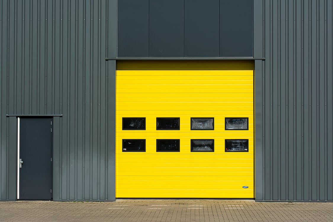 A yellow high-speed fabric door at a commercial building 